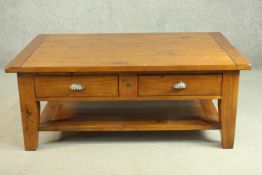 An Irish Coast Collection stained pine coffee table, the rectangular top over two short drawers with