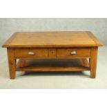 An Irish Coast Collection stained pine coffee table, the rectangular top over two short drawers with