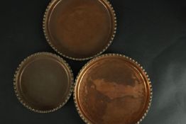 Three 19th century crimped edged heavy copper quiche dishes. One stamped BBB to the base. Dia.
