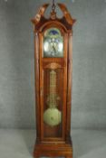 A reproduction American hardwood longcase clock, with a broken swan neck pediment and a glazed