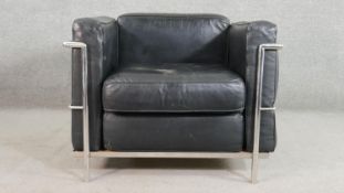 After Le Corbusier, an LC1 style armchair, with black leather cushions, within a chromed tubular