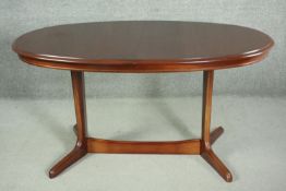 A G-Plan mahogany oval extending dining table, the top crossbanded, with integral butterfly leaf,