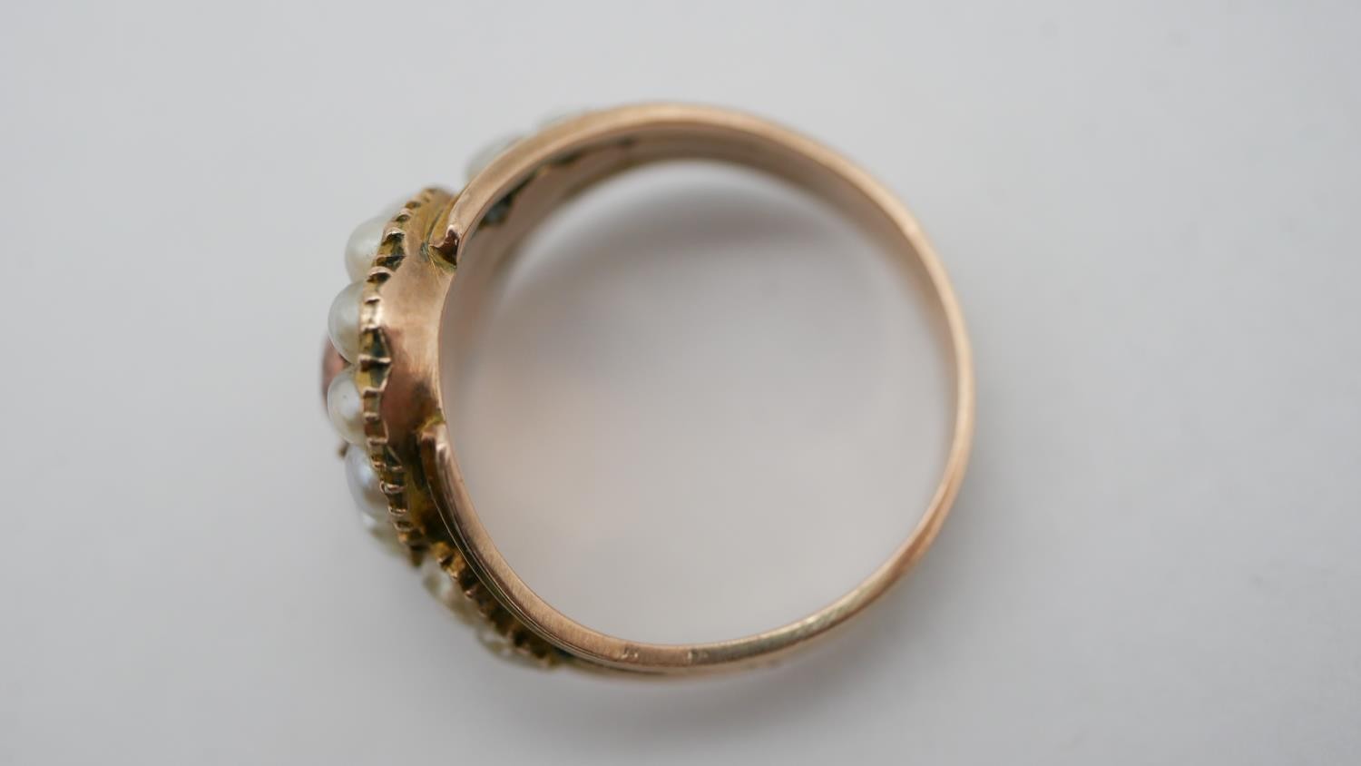 A Georgian pearl and topaz yellow metal cluster ring. Set to centre with an oval foil backed peach - Image 7 of 7