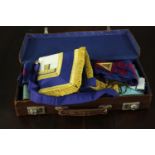 A brown leather carrying case containing various masonic items, including regalia and medals. H.20