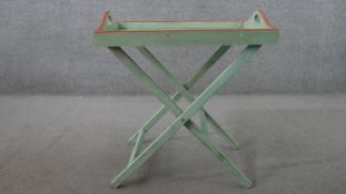 A green painted and distressed butler's tray, the tray decorated with a botanical study of