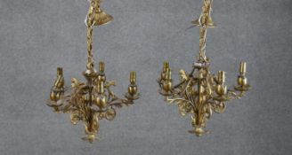 A pair of early 20th century stylised foliate and floral design gilt brass five branch