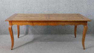 A 19th century French cherrywood farmhouse dining table, the rectangular cleated plank top over an