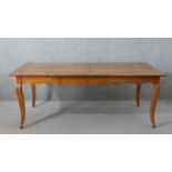 A 19th century French cherrywood farmhouse dining table, the rectangular cleated plank top over an