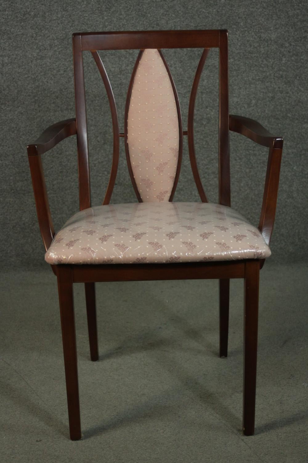 A G-Plan stained beech carver, with an eliptical padded back, on square section legs