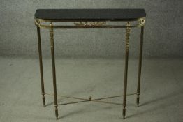 A late 20th century gilt metal console table, with a black glass top, on fluted legs. H.79 W.75 D.