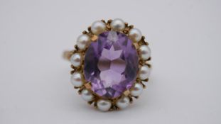 A Victorian 9 carat yellow gold amethyst and cultured pearl cluster ring. Set to centre with an oval