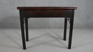 A late 18th century George III mahogany rectangular tea table, with a foldover top, the square