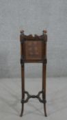 A French walnut planter, the square top with knob finials and caned sides, on cylindrical splayed