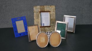 A collection of easel backed picture frames, including three silver picture frames. H.26 W.21cm (