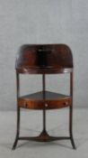 A George III mahogany corner washstand of typical form, with a single drawer flanked by two faux