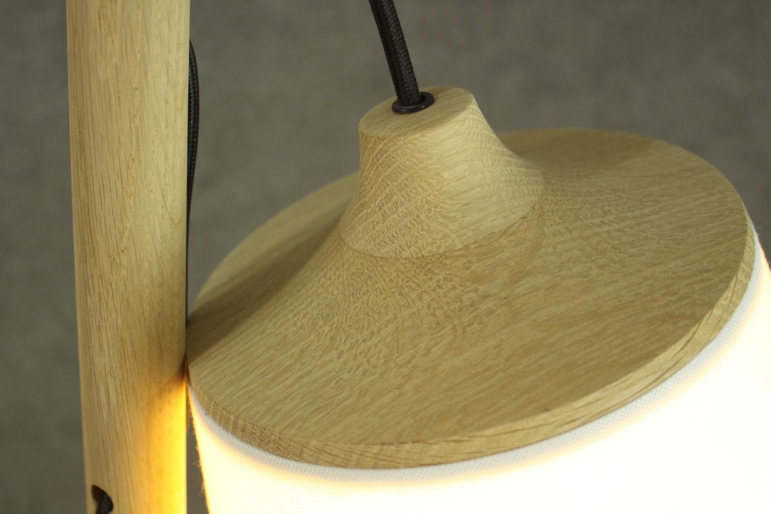 A contemporary light oak standard lamp, the white shade hanging from a cylindrical stem, on a - Image 7 of 7