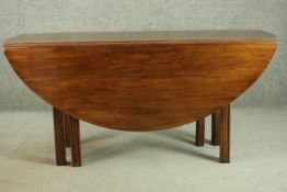 A Georgian fruitwood drop leaf dining table, of oval form, with gateleg supports. H.74 W.158 D.141(