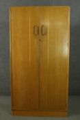 A mid 20th century E Gomme of High Wycombe oak wardrobe with two doors, containing hanging space,