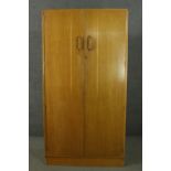 A mid 20th century E Gomme of High Wycombe oak wardrobe with two doors, containing hanging space,
