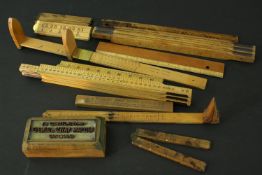 A collection of 19th and early 20th century rulers and a brass printing block. Various makers. L.