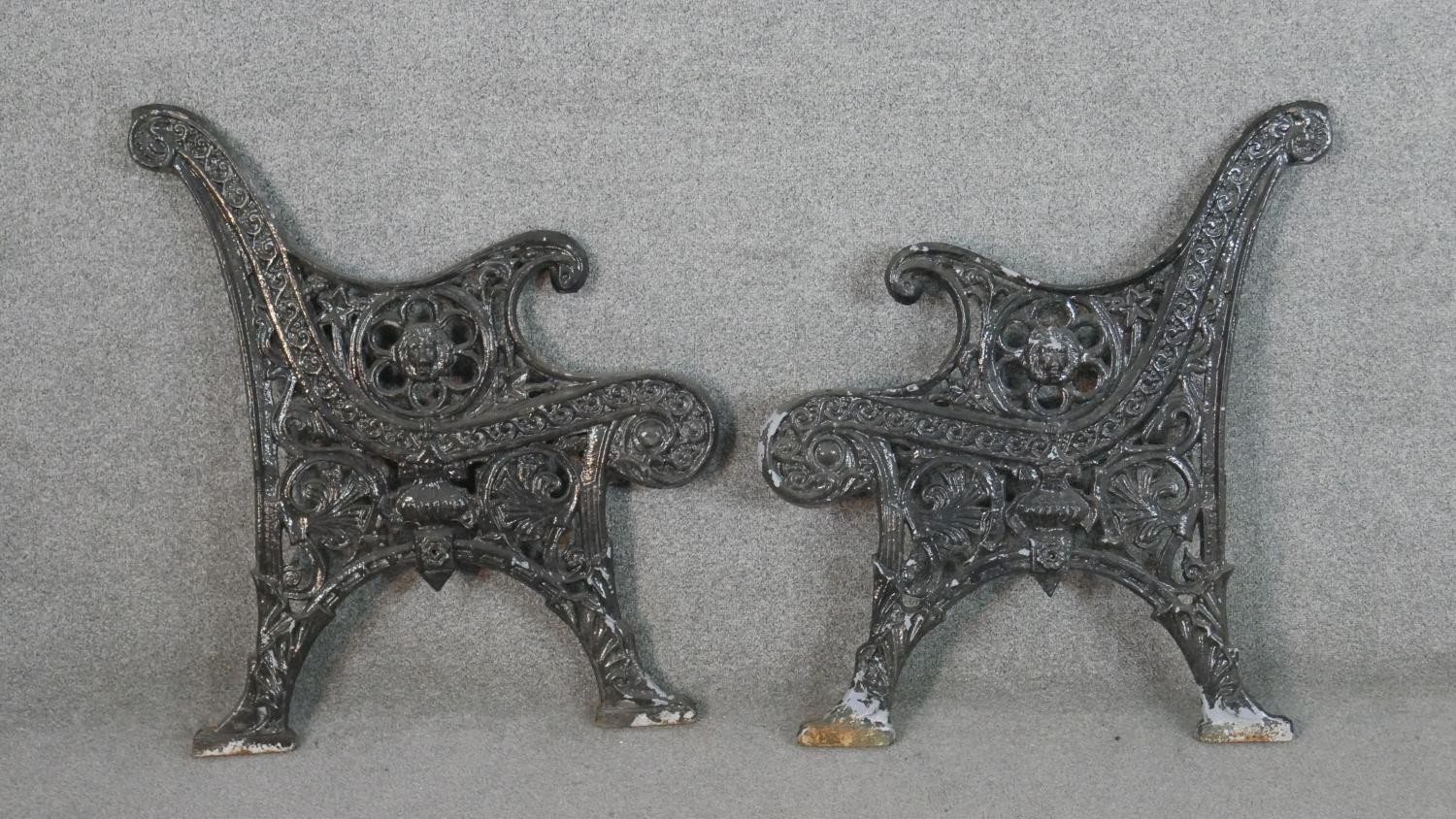 Two Victorian style painted cast iron bench ends. H.78 W.71cm