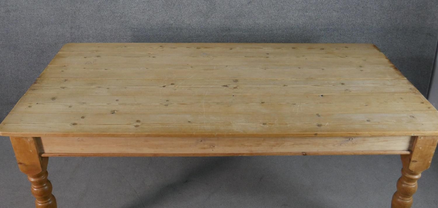 A Victorian pine planked top kitchen table, with an end drawer, on turned legs. H.75 W.186 D.97cm - Image 5 of 6