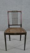 A Regency painted side chair, with a square spindle back, over a caned seat, on turned legs.