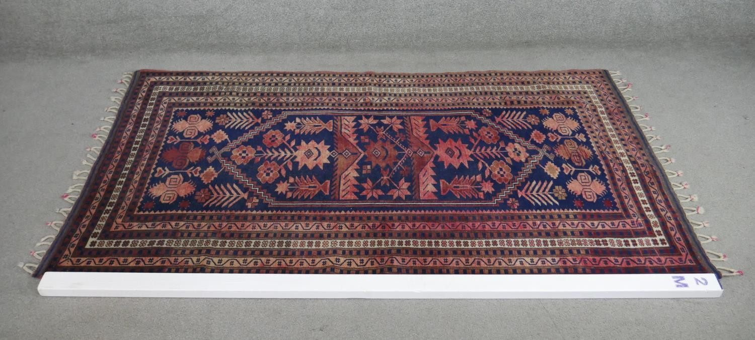 A handmade Turkish Yagcibedir rug, on a blue ground. L.108 W.118cm. - Image 2 of 7