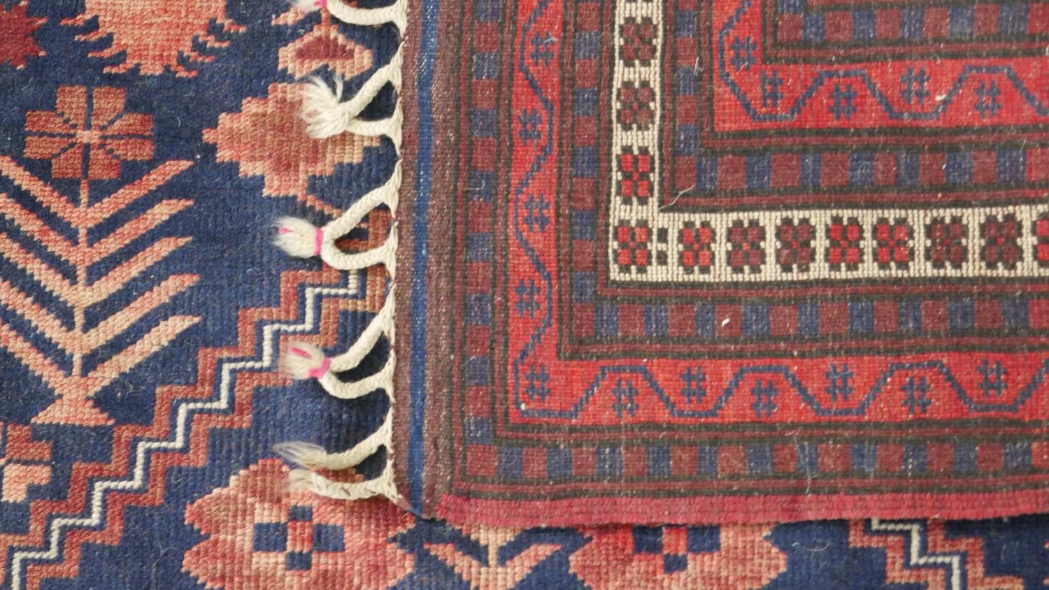 A handmade Turkish Yagcibedir rug, on a blue ground. L.108 W.118cm. - Image 7 of 7