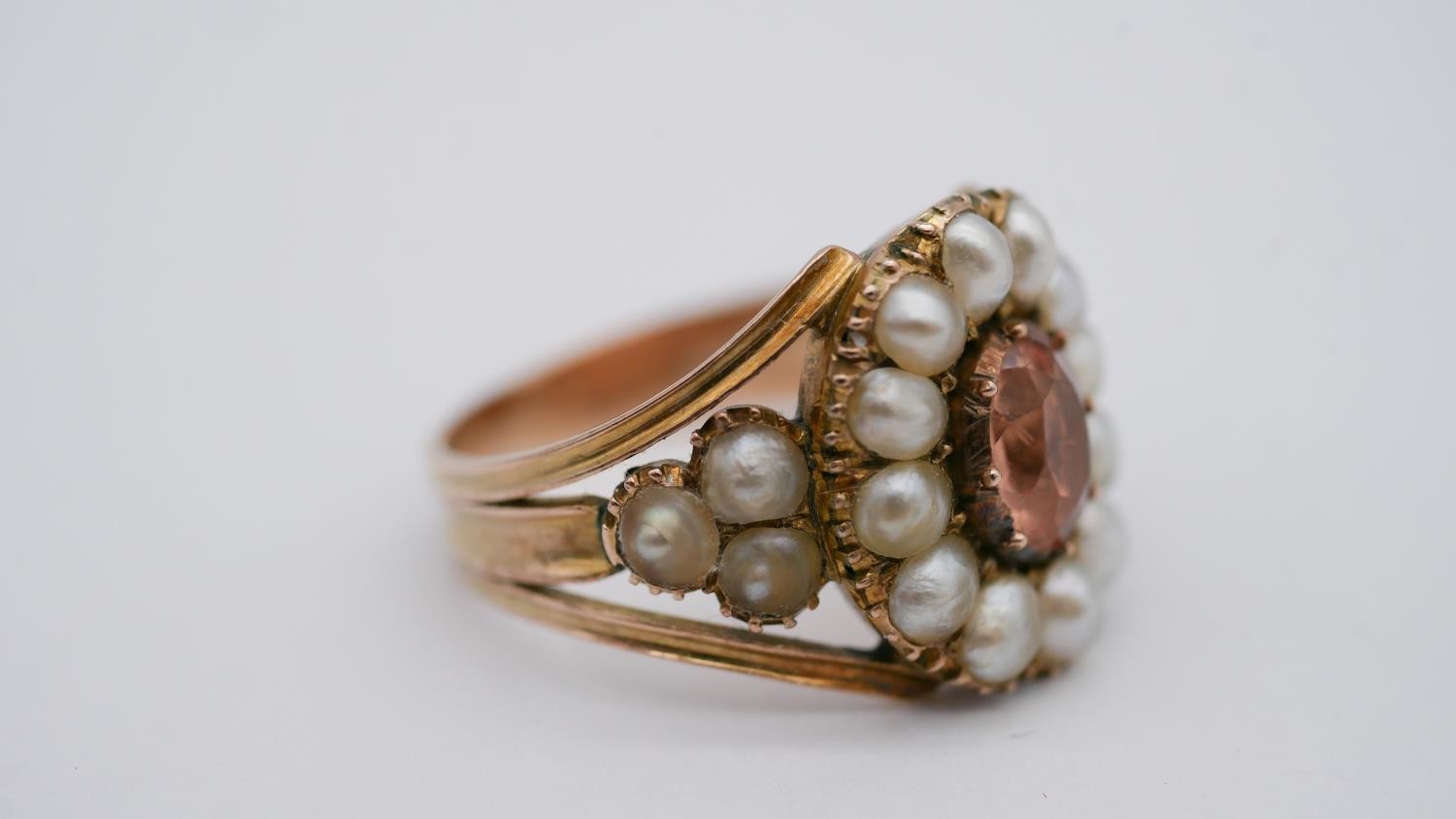 A Georgian pearl and topaz yellow metal cluster ring. Set to centre with an oval foil backed peach - Image 2 of 7