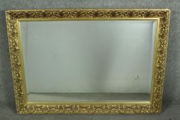 A late 20th century gilt framed mirror, of rectangular form with a bevelled mirror plate along