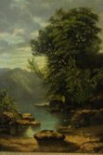 A gilt framed 19th century oil on board of a lake scene with mountains in the background.