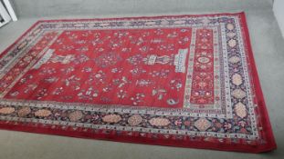 A woollen Keshan motif carpet, on a red ground. L.290 W.200cm.