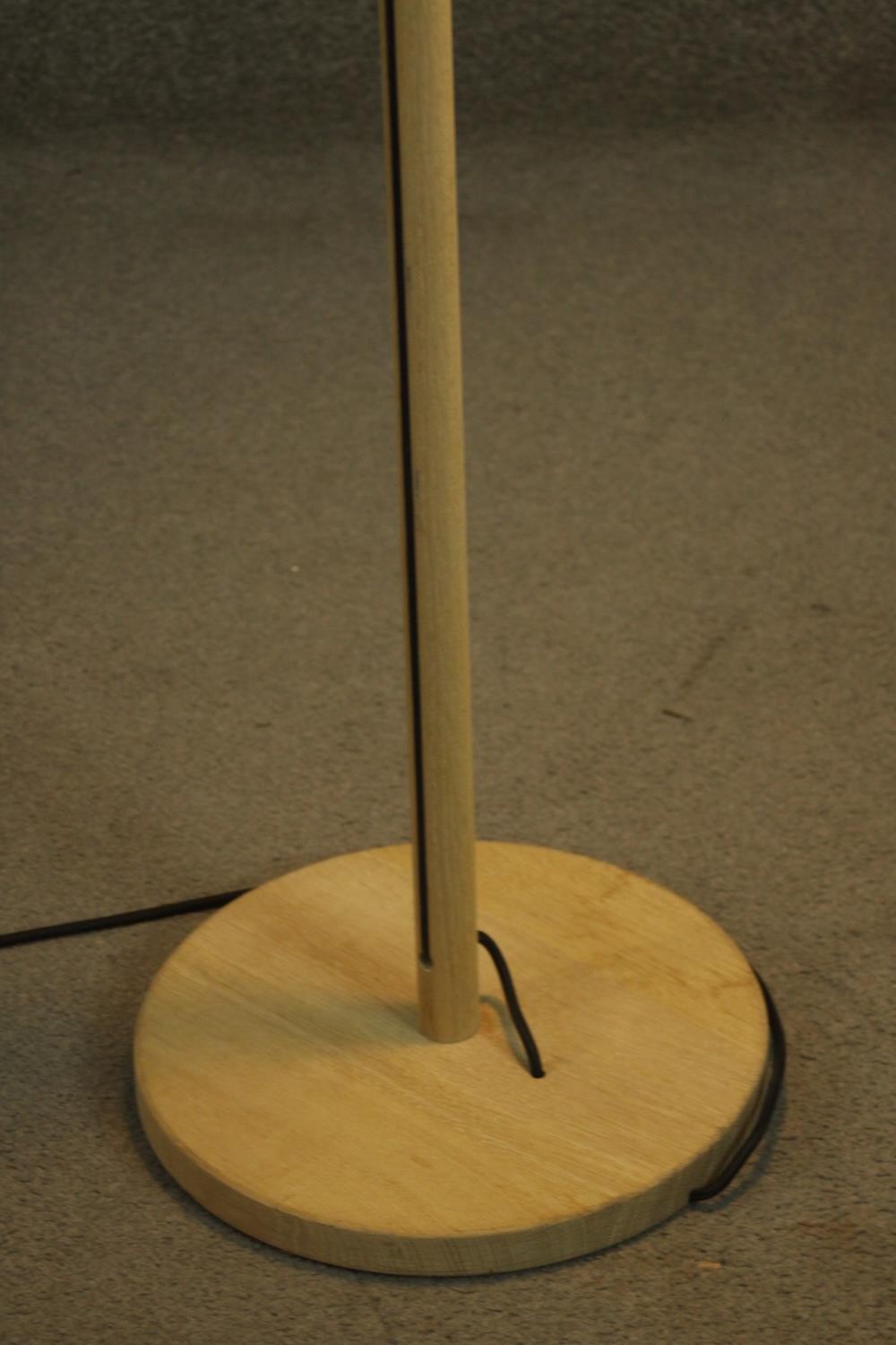 A contemporary light oak standard lamp, the white shade hanging from a cylindrical stem, on a - Image 6 of 7