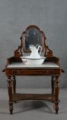 A 19th century mahogany washstand, fitted with swing mirror over a white marble top, above a