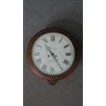 A late 19th / early 20th century circular mahogany framed wall clock, the enamelled dial with