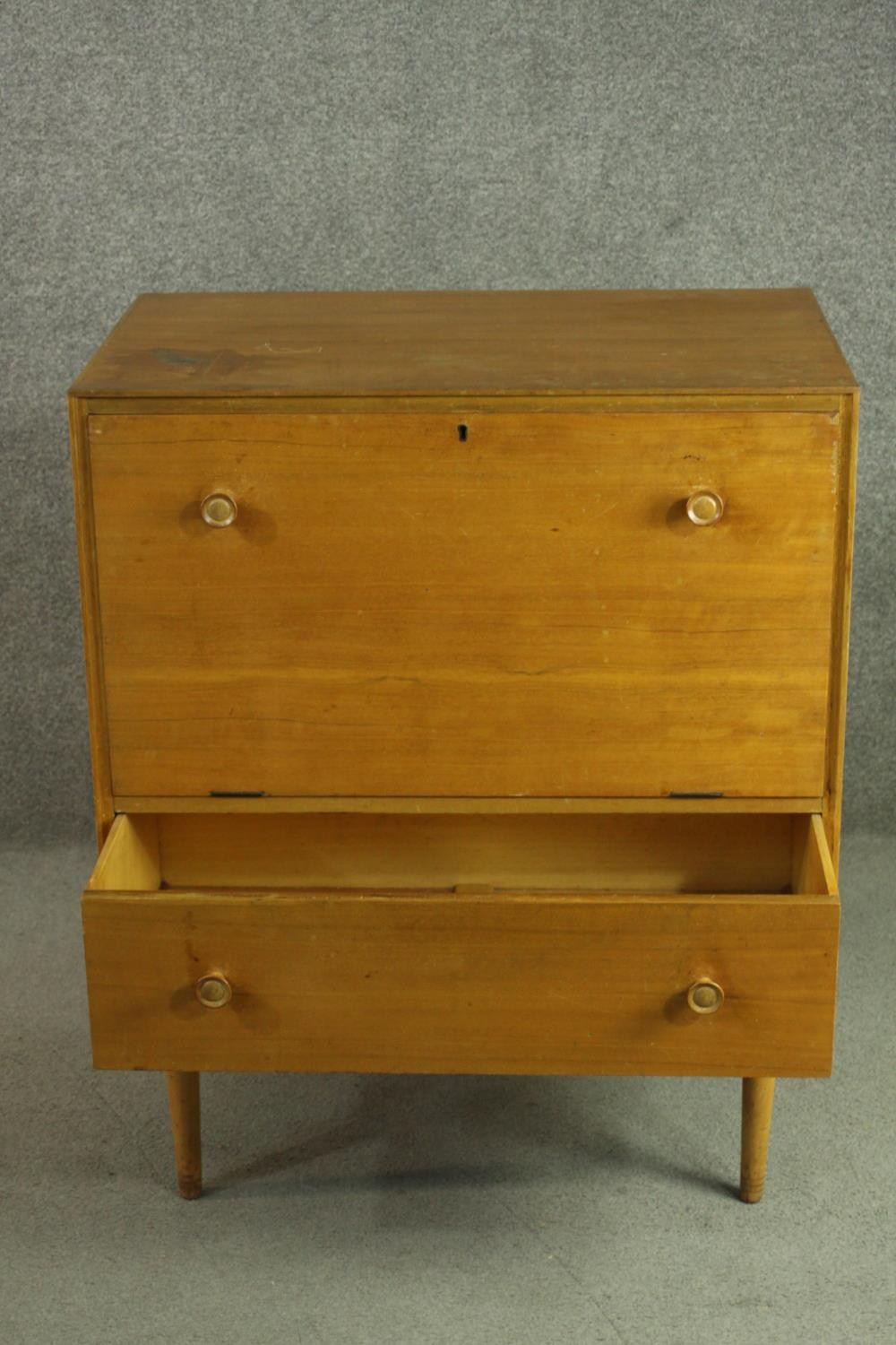 A circa 1950s teak cabinet, with a fall front enclosing a pull-out section, over a single drawer, on - Image 4 of 7