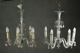 A near pair of 20th century Venetian style clear glass chandeliers, each with five scrolling