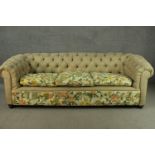 A Chesterfield three seater sofa, with a button back, upholstered in oatmeal fabric, the cushions