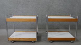 A pair of mid to late 20th century drinks or tea trolleys, with aluminium frames, and two white