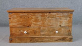 A contemporary aged pine mule chest, with a rectangular hinged top enclosing storage space over