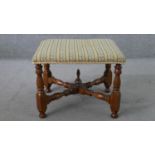 A Victorian walnut stool, upholstered in tapestry style fabric, on turned legs joined by turned X