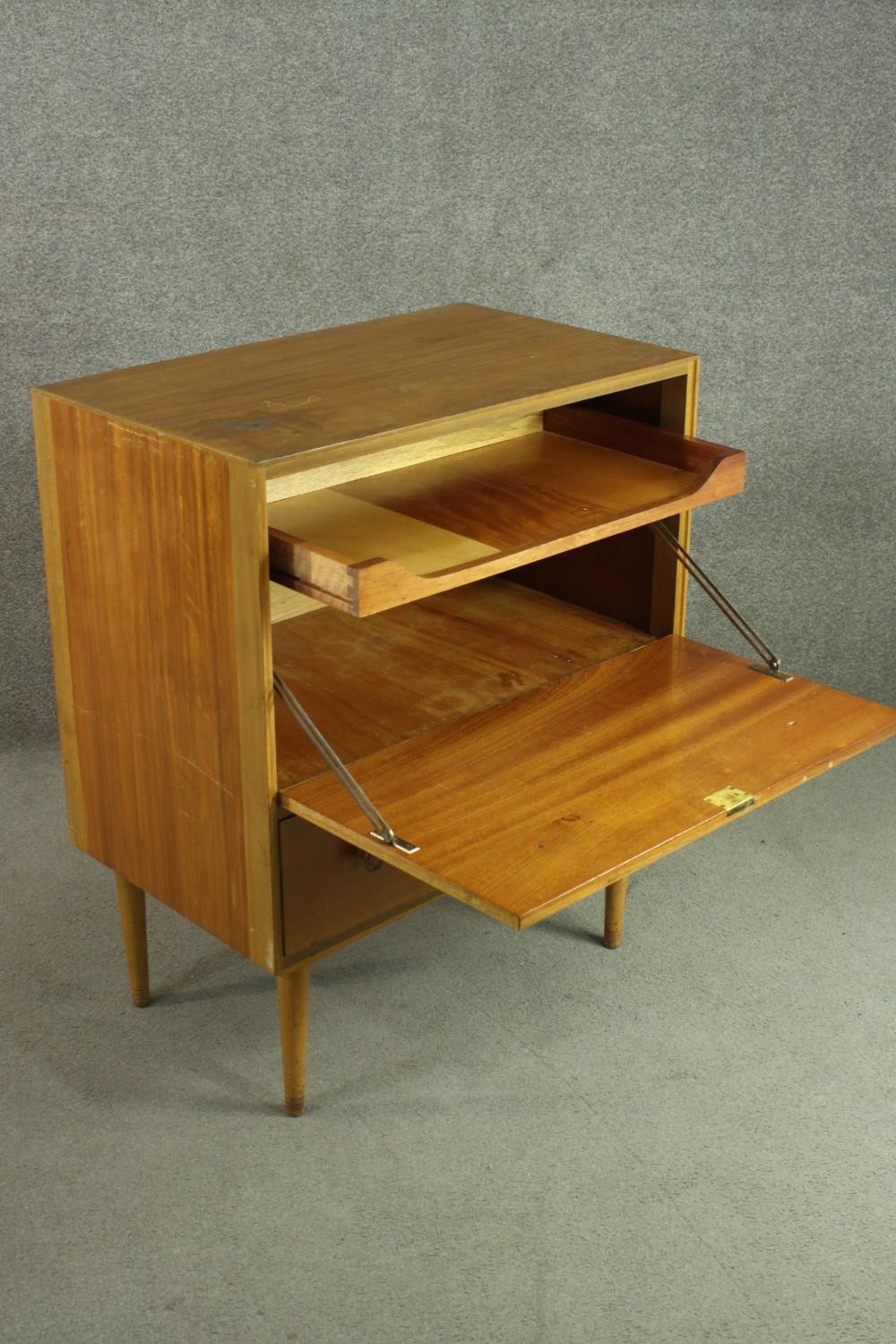 A circa 1950s teak cabinet, with a fall front enclosing a pull-out section, over a single drawer, on - Image 6 of 7