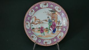A 19th century Famille Rose hand painted porcelain Chinese plate with figural design within a floral