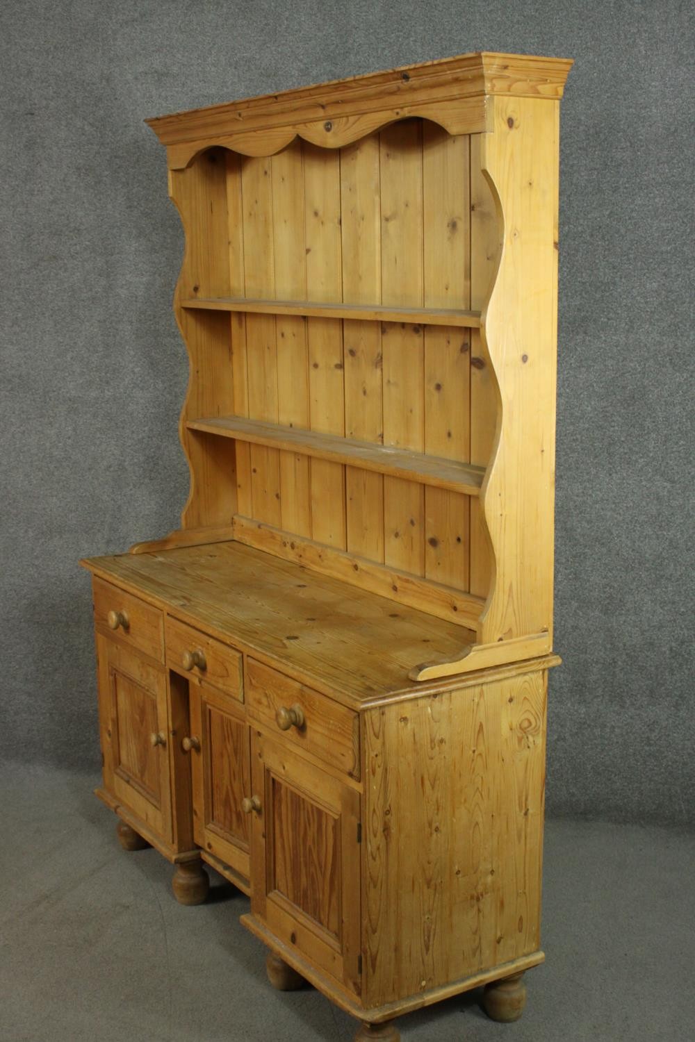 A Victorian style pine kneehole dresser with open plate rack above three short drawers over three - Image 6 of 8