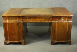 A Victorian walnut inverted breakfront partners desk, with a leather insert to the top, over nine