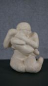 A 20th century carved limestone figure of mother and child. H.32 W.19 D.20cm