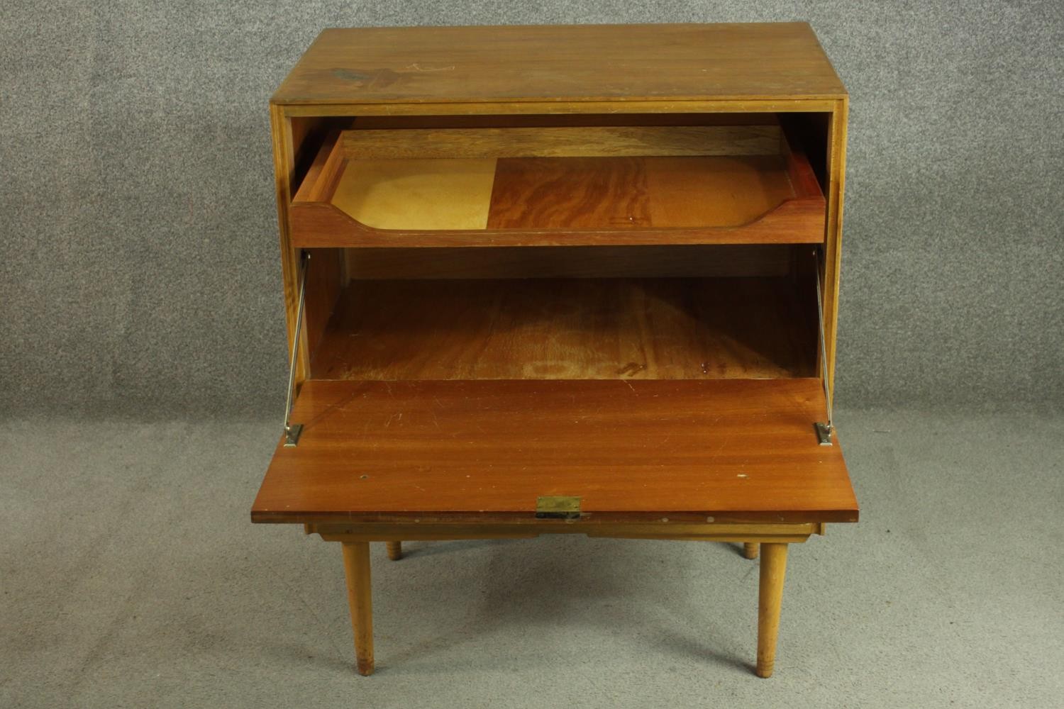 A circa 1950s teak cabinet, with a fall front enclosing a pull-out section, over a single drawer, on - Image 3 of 7