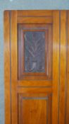 A late Victorian walnut wardrobe, the central door with a bevelled rectangular mirror plate, flanked