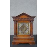 A Victorian architectural mantel clock, with an arched cornice over a frieze of roundels, above a